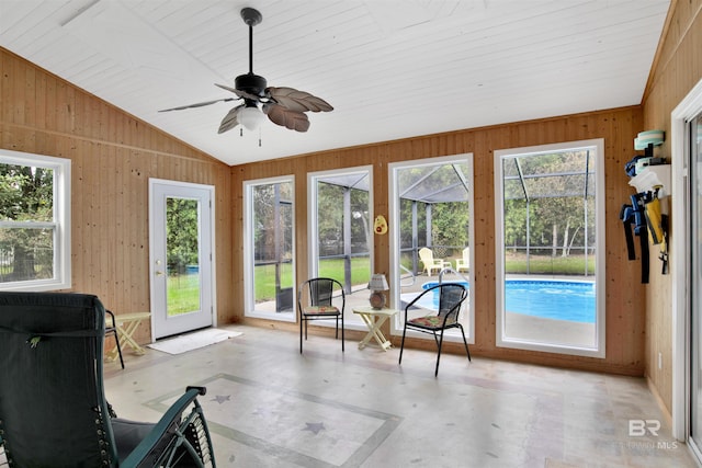 sunroom featuring lofted ceiling, plenty of natural light, and ceiling fan