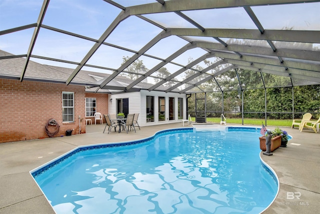 pool featuring a patio and glass enclosure