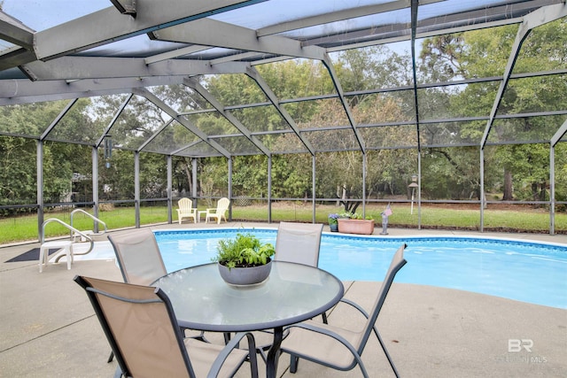 outdoor pool featuring glass enclosure, a yard, and a patio