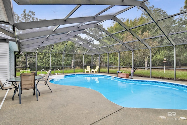 outdoor pool with a patio and glass enclosure