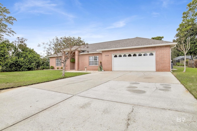 single story home featuring a garage, brick siding, a shingled roof, driveway, and a front yard