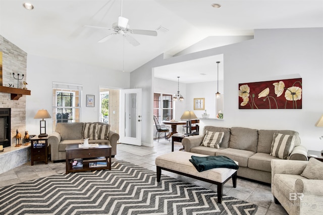 living room with a fireplace, visible vents, light tile patterned flooring, ceiling fan, and high vaulted ceiling