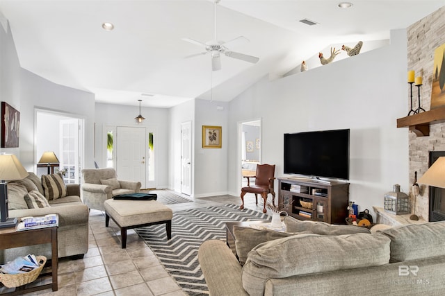 living area with visible vents, ceiling fan, a fireplace, high vaulted ceiling, and light tile patterned flooring