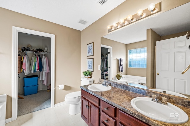 full bath featuring double vanity, a bath, visible vents, and a sink