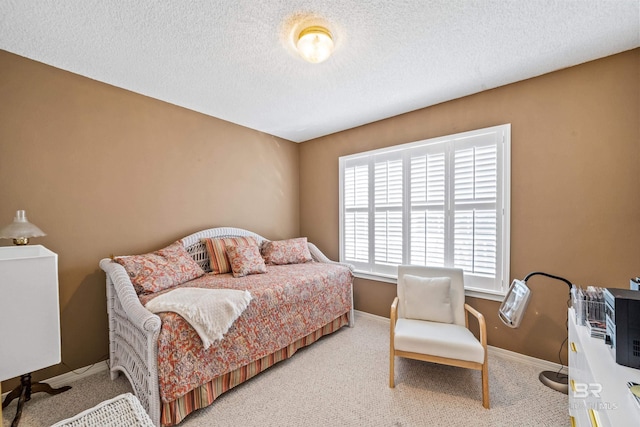 bedroom with baseboards, carpet flooring, and a textured ceiling