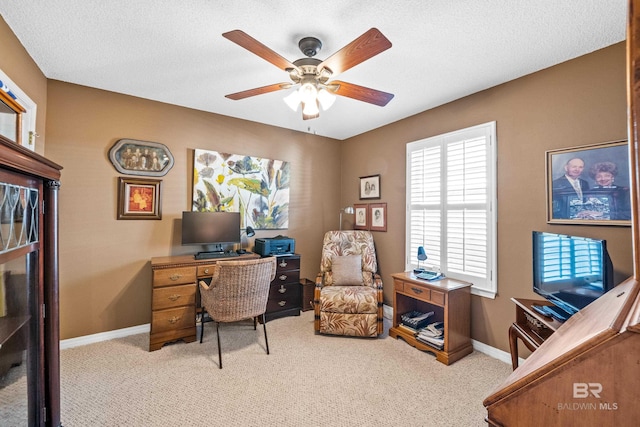 carpeted office space with baseboards, a ceiling fan, and a textured ceiling