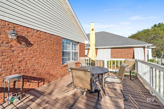 deck with outdoor dining area