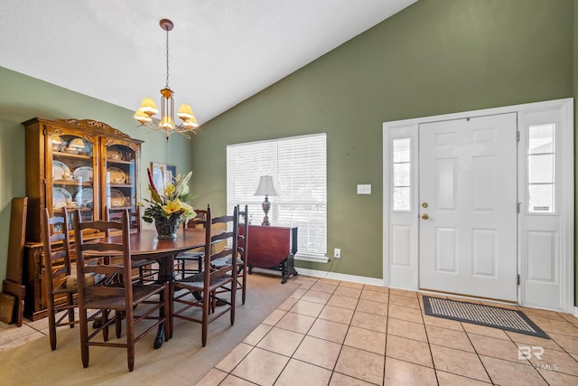 dining space with an inviting chandelier, light tile patterned floors, and high vaulted ceiling