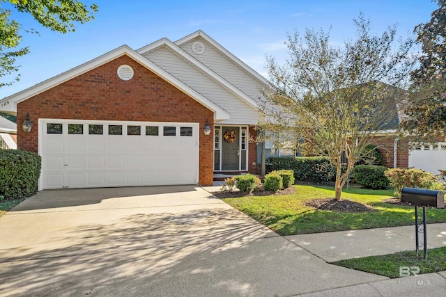 view of front of property with brick siding, an attached garage, a front yard, and concrete driveway