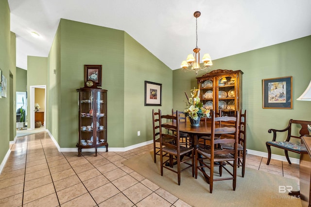 tiled dining area with an inviting chandelier and high vaulted ceiling