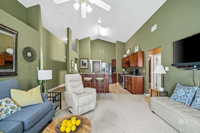 living room featuring visible vents, a ceiling fan, light colored carpet, light tile patterned flooring, and high vaulted ceiling