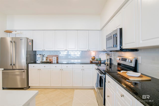 kitchen featuring white cabinets, backsplash, light tile patterned floors, and stainless steel appliances