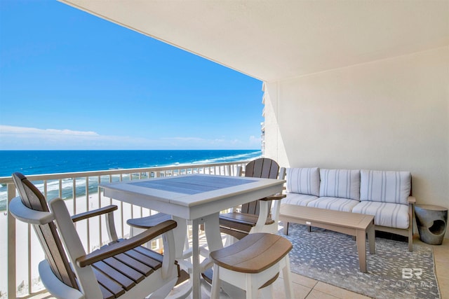 balcony featuring a beach view and a water view