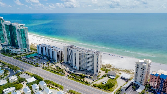 birds eye view of property with a water view and a view of the beach