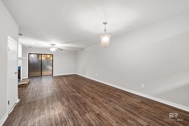 20 Summer Oaks Dr, Daphne, AL 36526 - spare room with dark wood-type flooring, a ceiling fan, and a fireplace with raised hearth