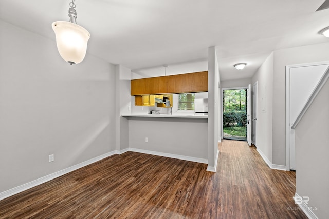20 Summer Oaks Dr, Daphne, AL 36526 - kitchen with dark wood finished floors, brown cabinets, light countertops, refrigerator, and pendant lighting
