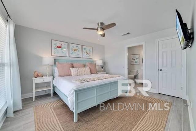 1492 Shell Ln, Gulf Shores, AL 36542 - bedroom with wood finished floors, ensuite bathroom, and ceiling fan