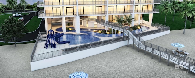 view of swimming pool featuring a patio and stairway