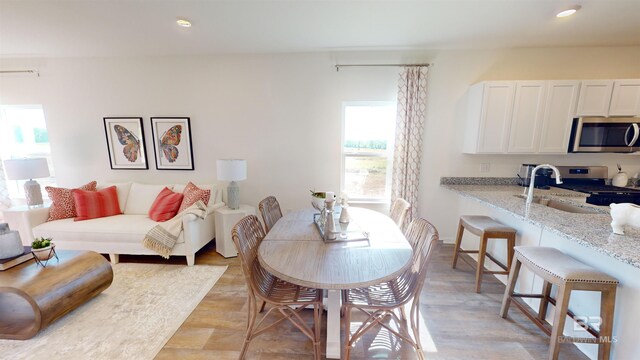 dining room featuring light hardwood / wood-style flooring and sink