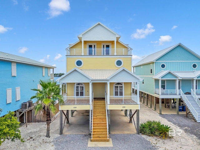 1328 W Lagoon Ave, Gulf Shores, AL 36542 - raised beach house with a carport, stairway, a balcony, and covered porch