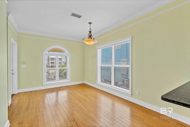 1328 W Lagoon Ave, Gulf Shores, AL 36542 - spare room featuring light wood-style flooring and ornamental molding
