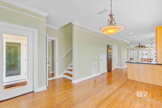 1328 W Lagoon Ave, Gulf Shores, AL 36542 - kitchen with freestanding refrigerator, dark countertops, ornamental molding, light wood-style floors, and a ceiling fan