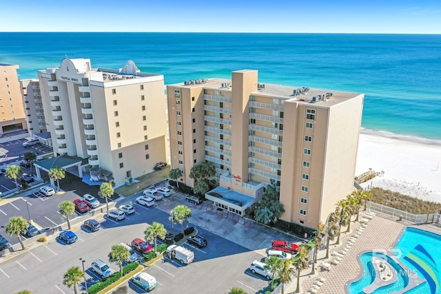 bird's eye view featuring a view of the beach and a water view