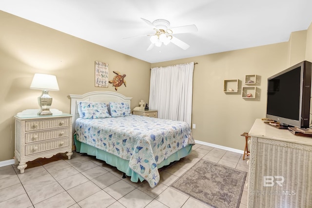 tiled bedroom featuring ceiling fan and baseboards