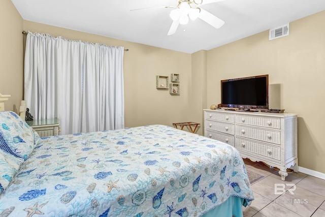 bedroom featuring visible vents, ceiling fan, baseboards, and light tile patterned floors