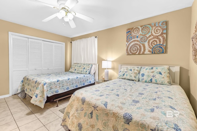 bedroom featuring a closet, light tile patterned flooring, and a ceiling fan