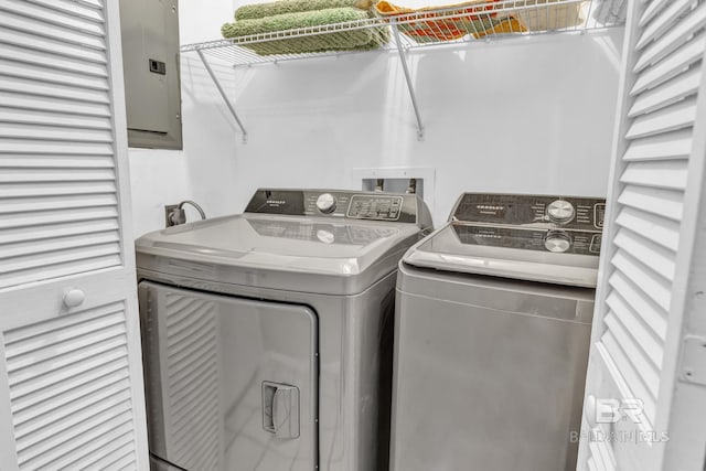 washroom featuring laundry area, electric panel, and washer and clothes dryer