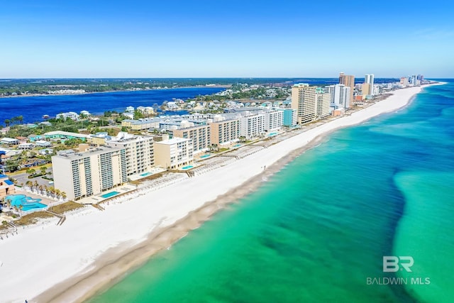 bird's eye view featuring a water view, a view of city, and a beach view