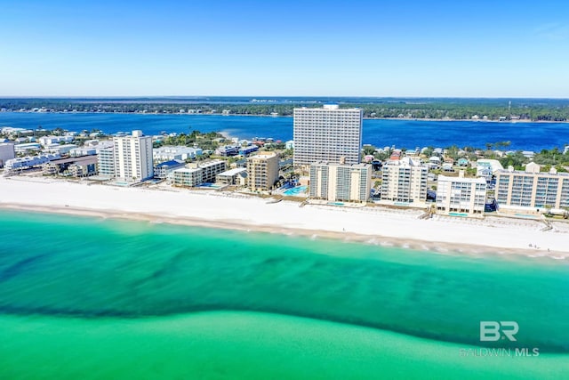 birds eye view of property featuring a water view and a beach view