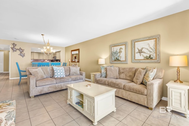 living area with light tile patterned floors, baseboards, and a chandelier