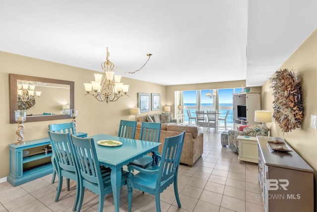 dining space with light tile patterned floors and an inviting chandelier