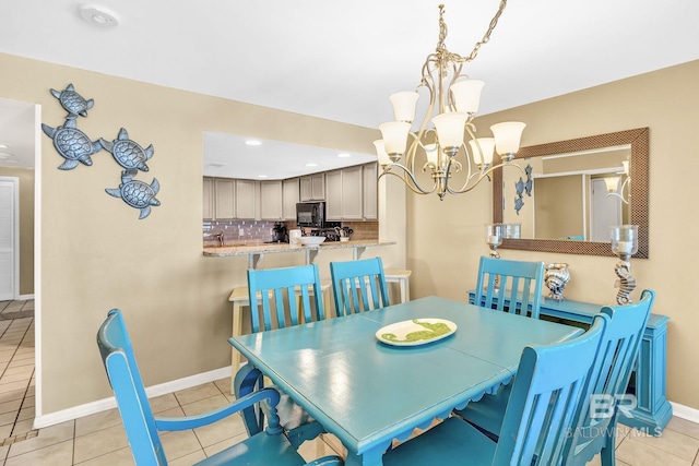 dining room featuring light tile patterned floors, baseboards, a notable chandelier, and recessed lighting