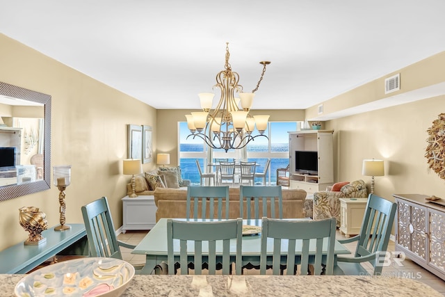 dining room with visible vents, a notable chandelier, and light tile patterned flooring