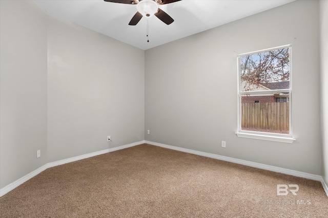 carpeted empty room featuring ceiling fan