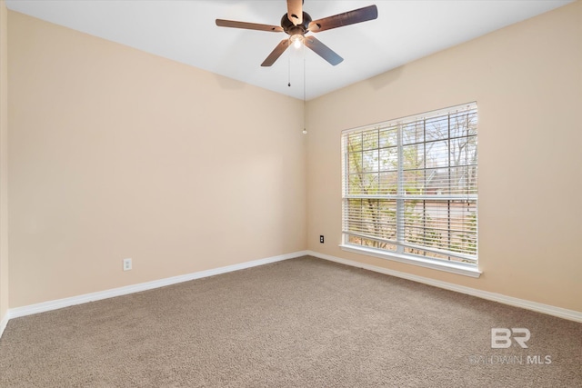 carpeted empty room featuring ceiling fan