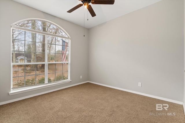 carpeted empty room featuring ceiling fan