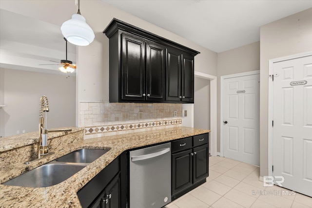 kitchen featuring sink, dishwasher, tasteful backsplash, light tile patterned flooring, and decorative light fixtures