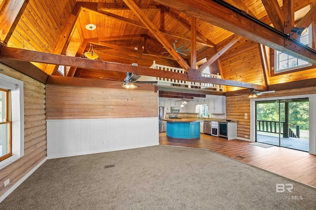 unfurnished living room featuring ceiling fan, high vaulted ceiling, wooden ceiling, and beamed ceiling