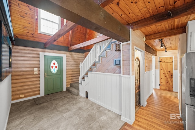 entryway featuring light hardwood / wood-style flooring, a skylight, track lighting, wooden ceiling, and beamed ceiling