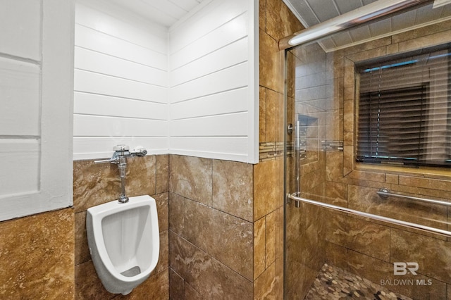 bathroom featuring a shower with door