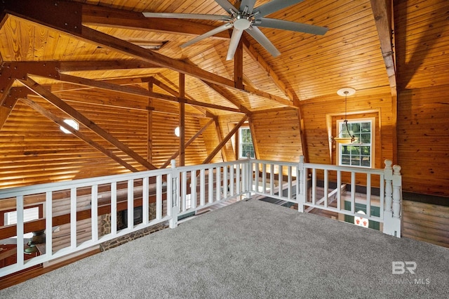 interior space featuring wood ceiling, wooden walls, and lofted ceiling with beams