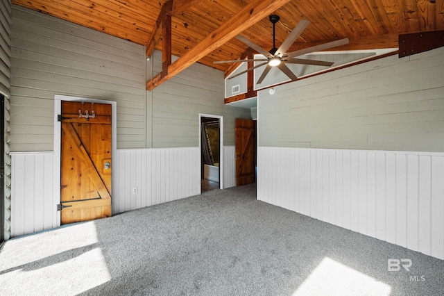 carpeted spare room with vaulted ceiling with beams, ceiling fan, and wooden ceiling