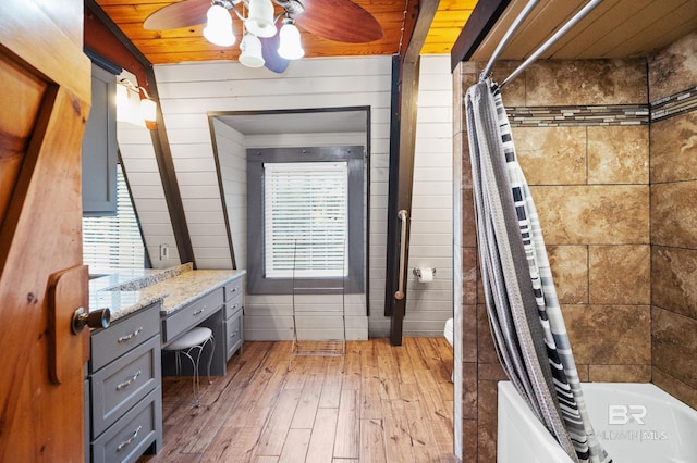 bathroom featuring shower / tub combo with curtain, hardwood / wood-style flooring, ceiling fan, vanity, and wooden ceiling
