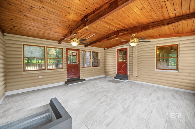 interior space featuring ceiling fan, wooden ceiling, and vaulted ceiling with beams