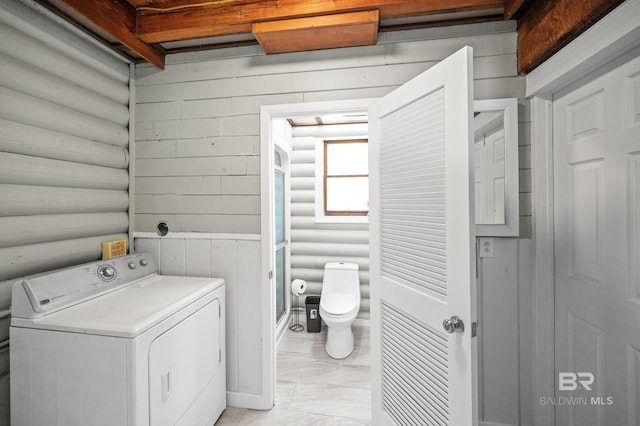 laundry room with washer / clothes dryer and rustic walls