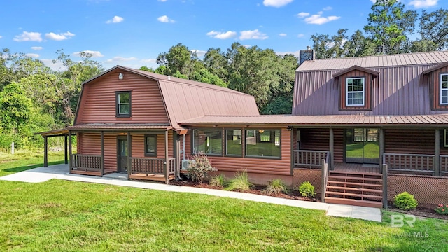 cabin with a front yard and covered porch